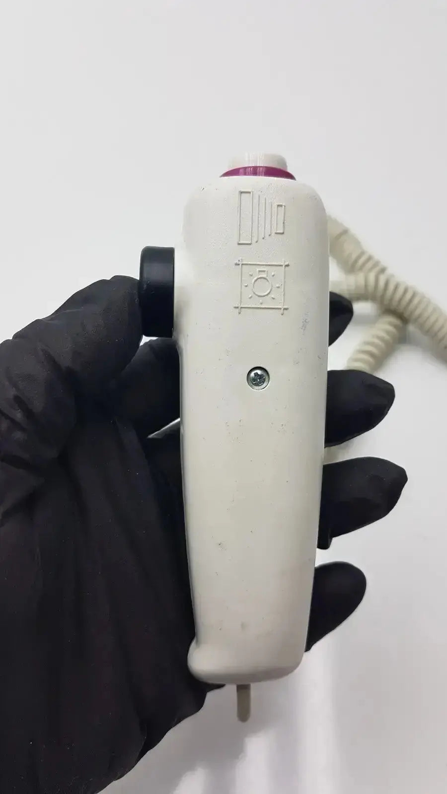 White plastic dragonfly hand switch with black grip purple accent and engraved symbols for precise control