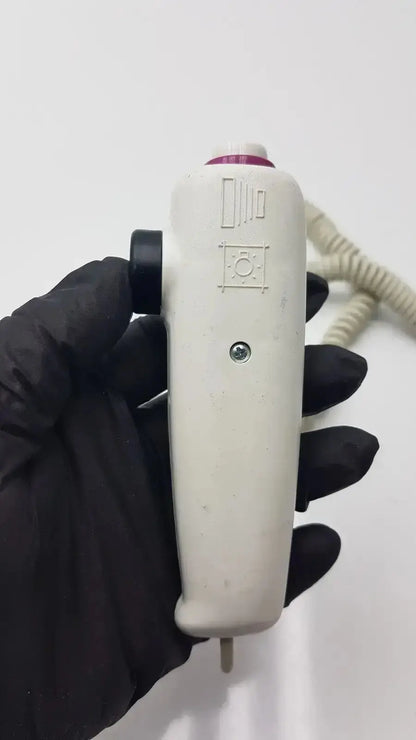 White plastic dragonfly hand switch with black grip purple accent and engraved symbols for precise control