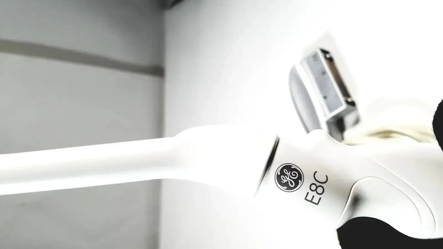 White ge e8c electric kettle with sleek glossy finish shown alongside ultrasound probe transducer endo vaginial device