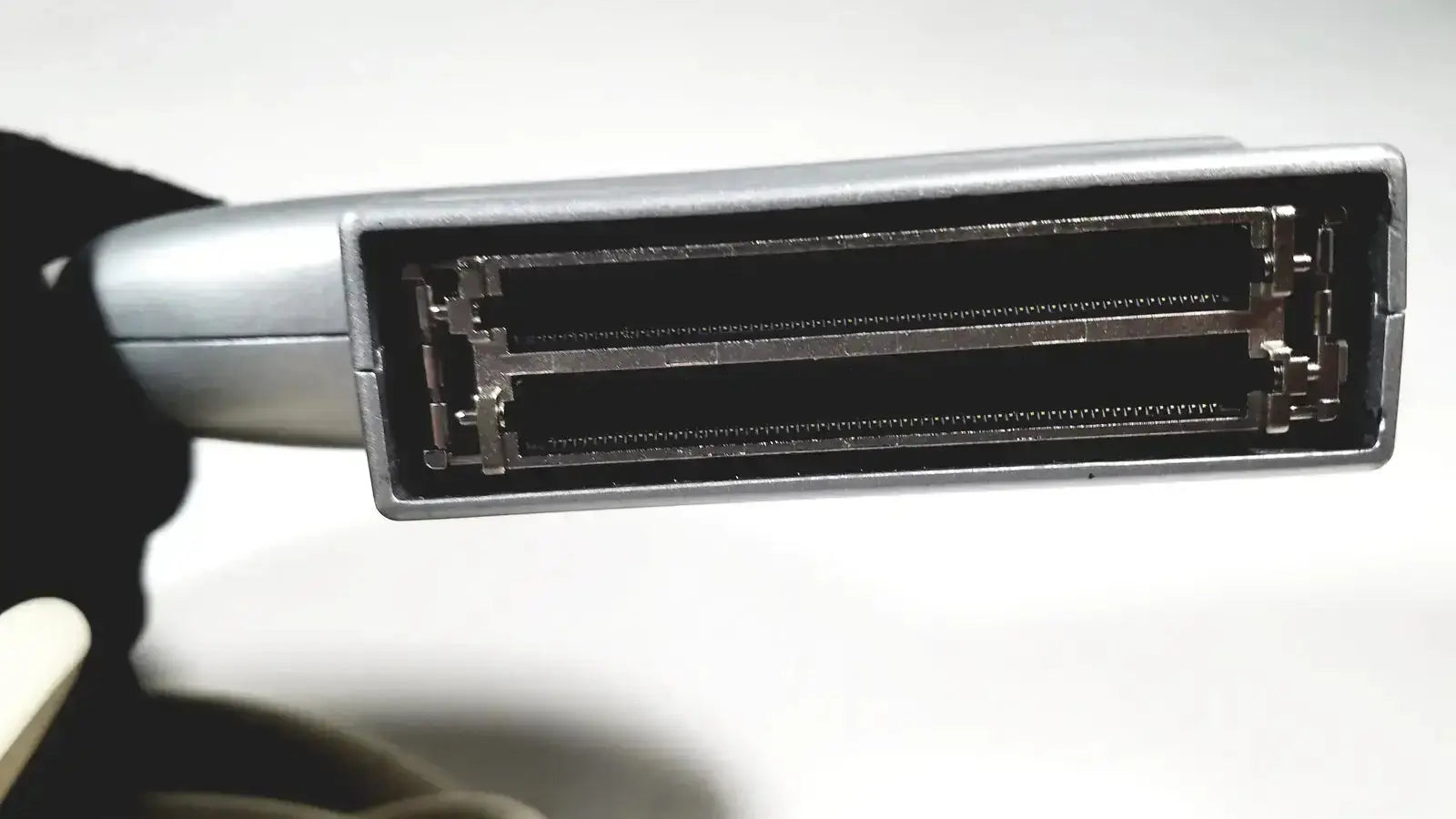 Silver-colored rectangular ge e8c-rs ultrasound probe transducer endo vaginal with two rows of metallic contacts inside black housing