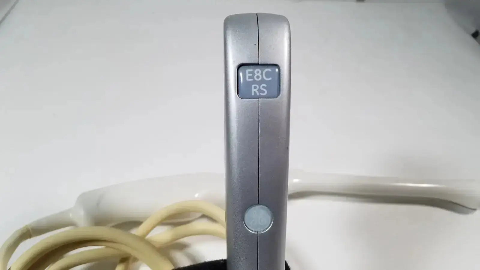 Silver-colored sleek rectangular e8c-rs endovaginal ultrasound probe remote control with matte finish and two buttons