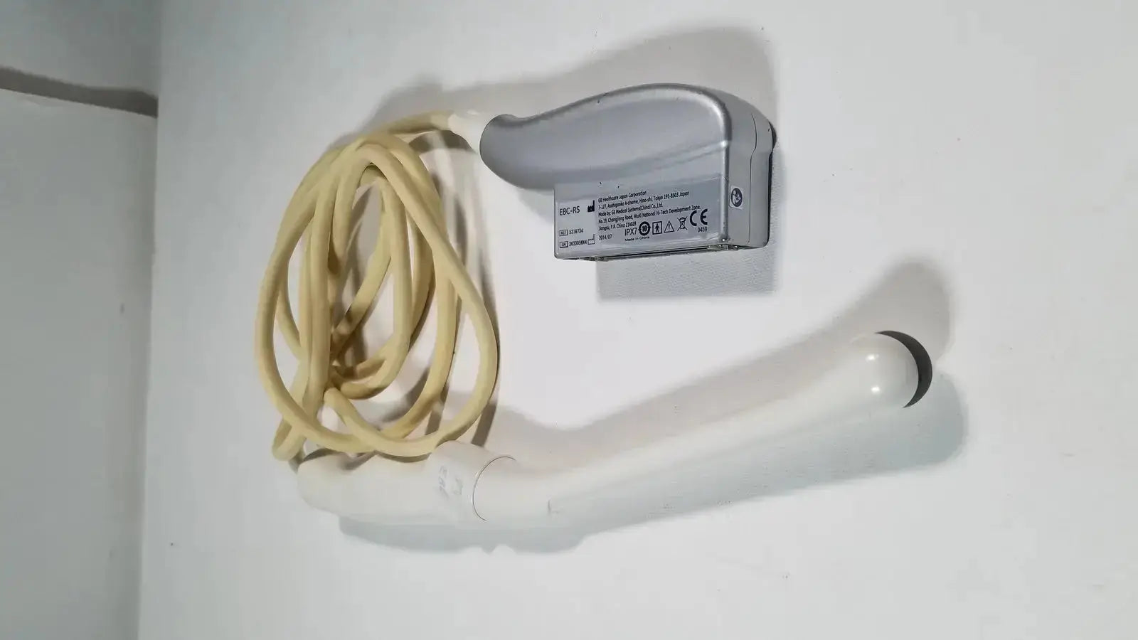 Silver ge e8c-rs endovaginal ultrasound probe transducer with beige cable and white probe tip for endovaginal ultrasound