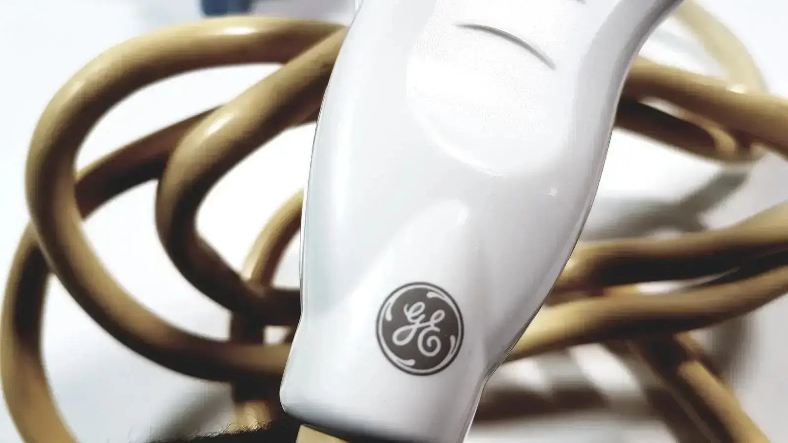 White ge healthcare 11l linear array ultrasound transducer probe with glossy handle and coiled tan electric cord