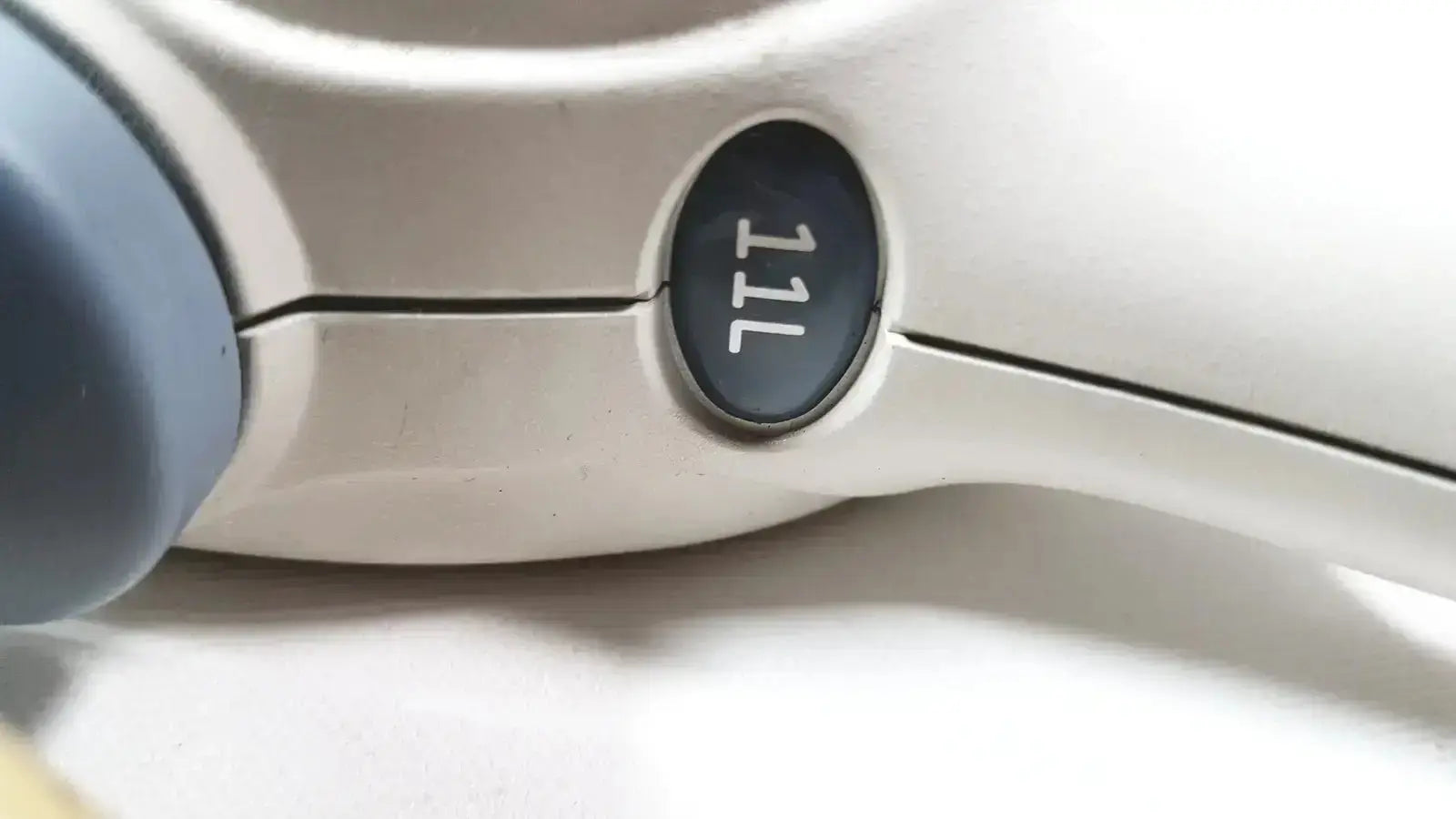 White and gray GE Healthcare 11L linear array ultrasound transducer probe with black oval button labeled 11l