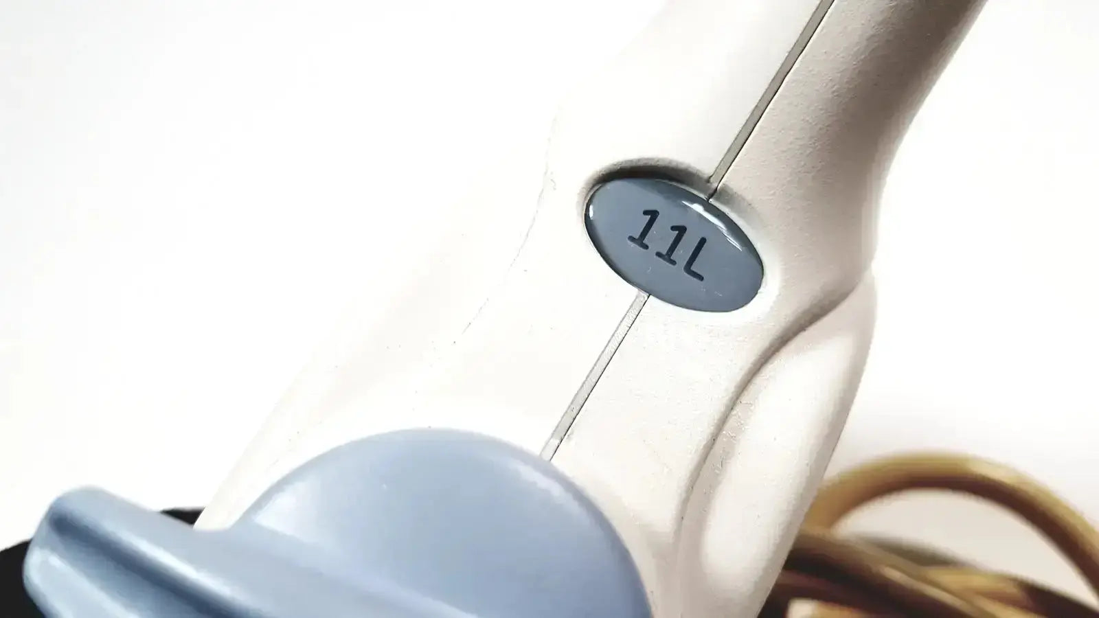 Beige handheld steam cleaner with gray 11l label used in healthcare 11l linear array ultrasound transducer probe