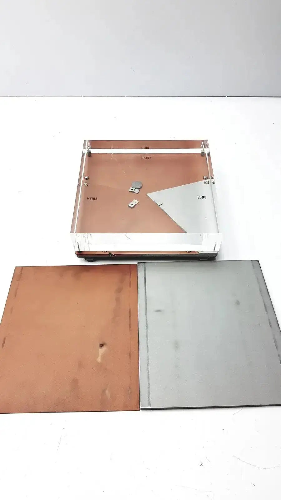 Clear acrylic tray with copper and silver metallic inserts used in ge healthcare cardiovascular phantom for pre owned medical equipment sale