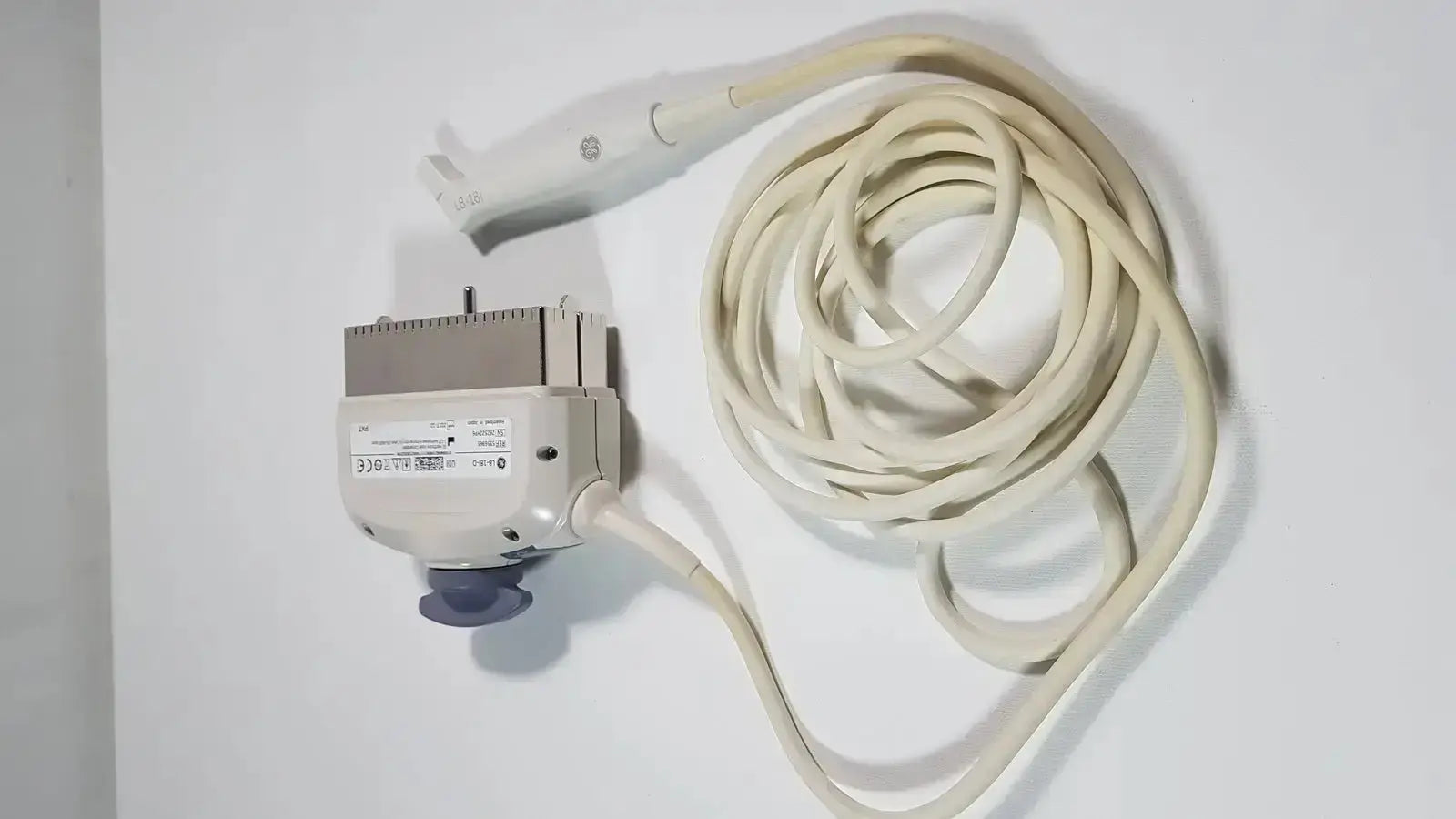 Cream-colored ge l8-18i-d linear array ultrasound transducer with coiled cable and rectangular housing for array ultrasound