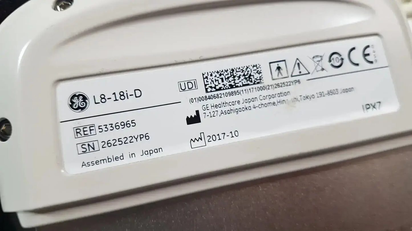 White plastic ge l8-18i-d linear array ultrasound device label showing serial number and regulatory markings