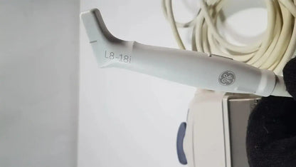 White ge l8-18i-d linear array ultrasound transducer with ergonomic design and smooth plastic finish for medical imaging