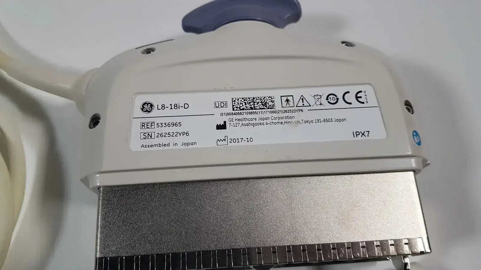 Beige ge l8-18i-d linear array ultrasound transducer with silver metallic connector and blue handle for array ultrasound use