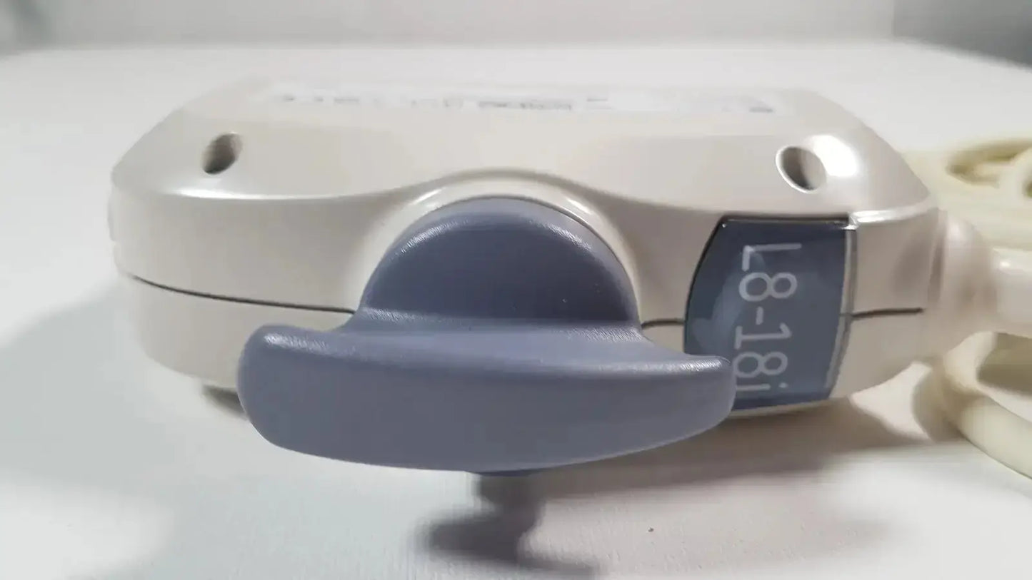 Beige plastic electric outlet extender with gray toggle switch and blue l8-18i label for ge l8-18i-d linear array ultrasound