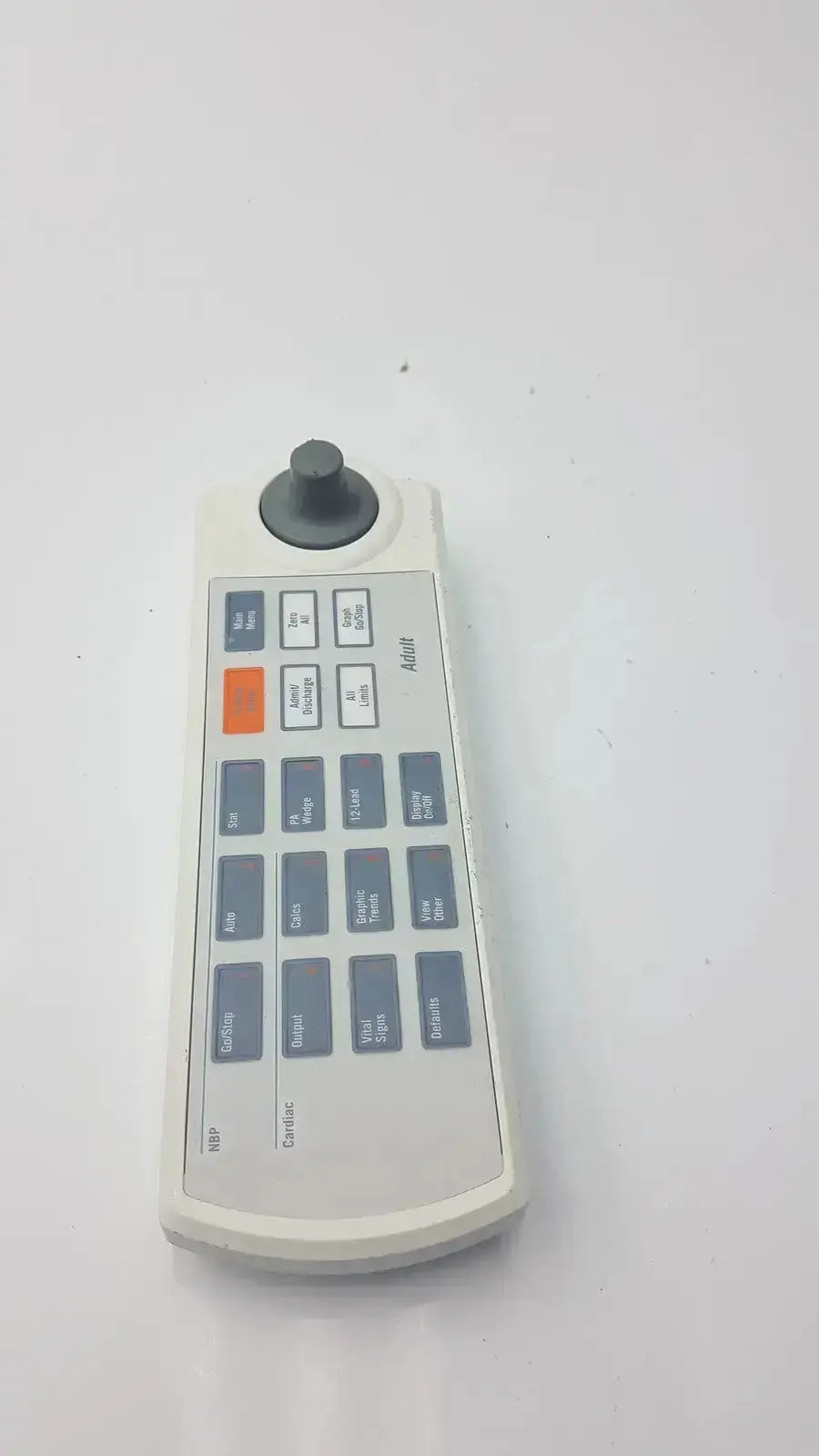 White plastic remote keypad for marquette solar 8000m-8000i with black joystick gray buttons and an orange button