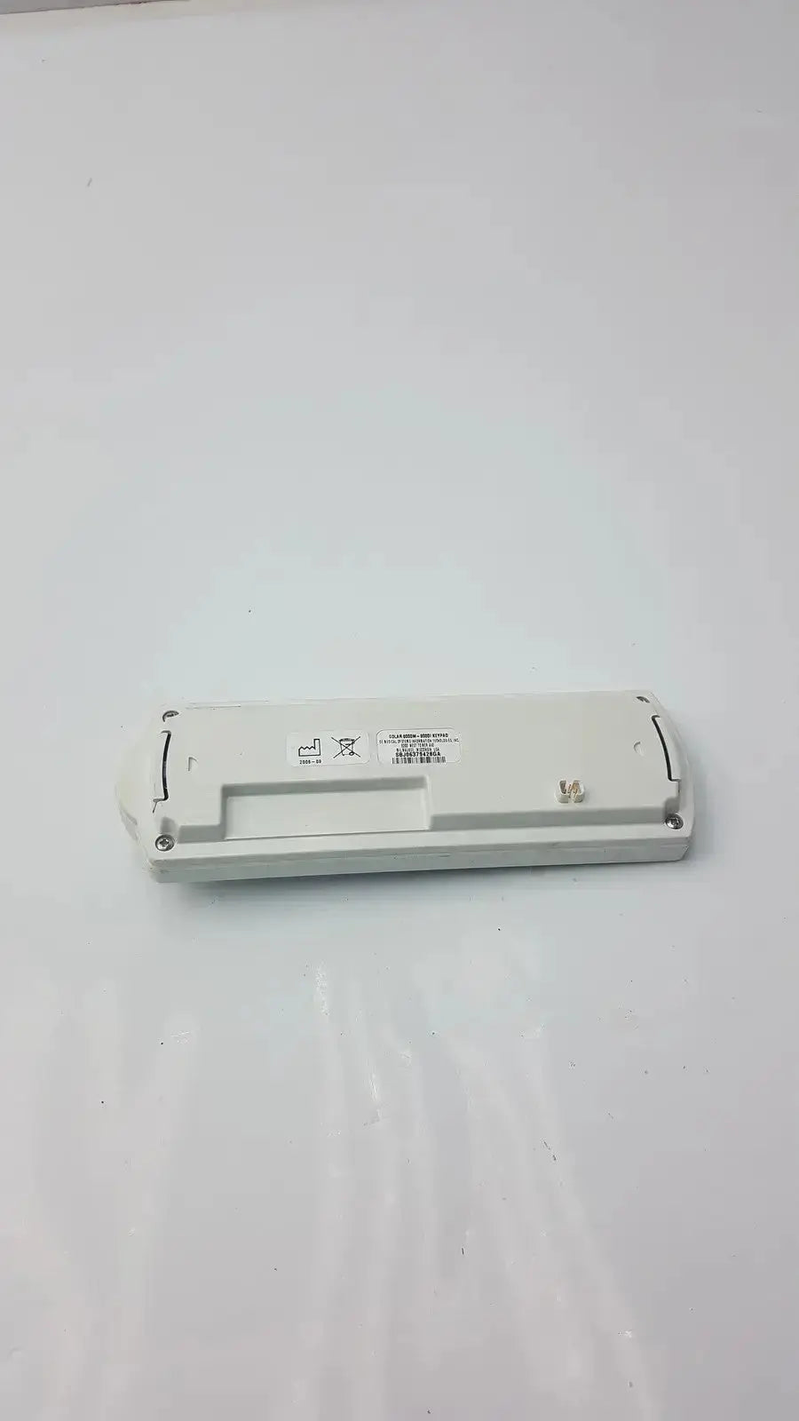 White plastic rectangular battery with printed markings for marquette solar 8000m-8000i remote keypad use