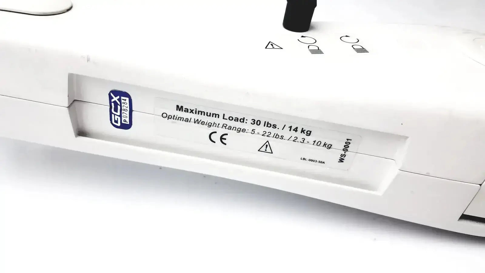 White gcx p7854 industrial scale with black markings shown on the back of ge marquette housing module 250sl with gcx monitor mount