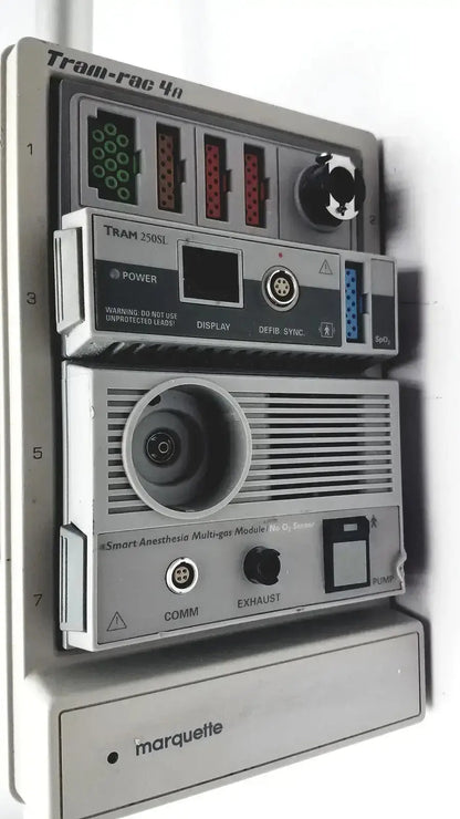 Gray plastic ge marquette tram-rac 4a housing module 250sl with labeled ports and gcx monitor mount arm backside view