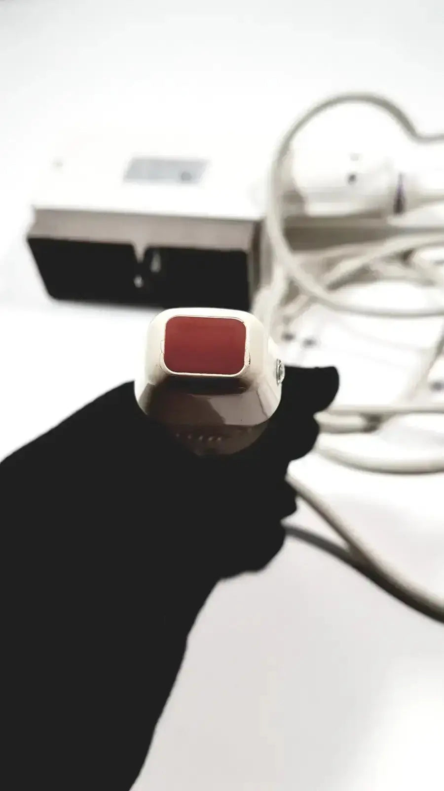 White and red handheld epilator with sleek modern design featured alongside GE medical phased array probe for Logiq and Vivid series