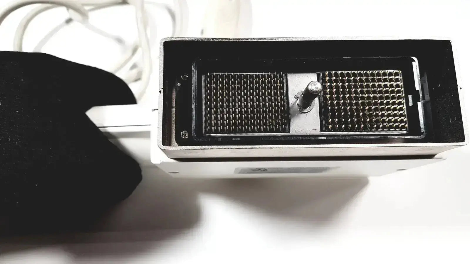 White rectangular GE medical phased array probe with two black grid panels and central metallic knob for ultrasound use