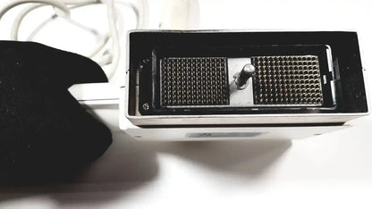 White rectangular GE medical phased array probe with two black grid panels and central metallic knob for ultrasound use