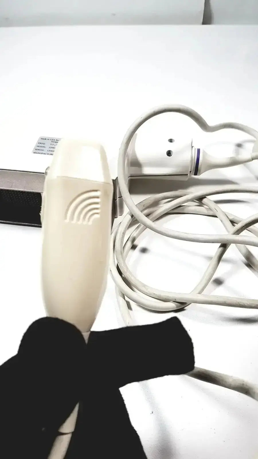 Cream-colored phased array probe with curved ergonomic design and wave-like grooves for ge medical ultrasound systems