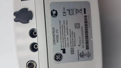 White plastic label with black text and symbols on ge healthcare corometrics 171 external fetal monitor device