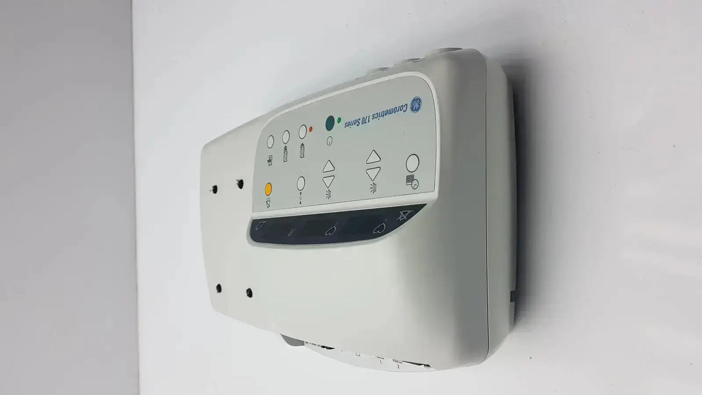 Gray ge comportus 128 series wall-mounted external fetal monitor with illuminated control panel buttons and icons