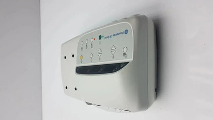 Gray ge comportus 128 series wall-mounted external fetal monitor with illuminated control panel buttons and icons
