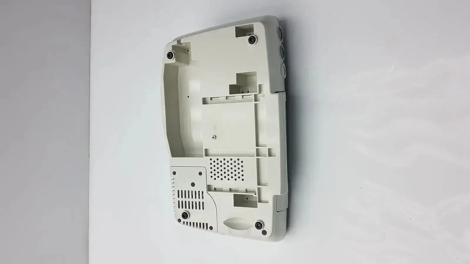 Off-white plastic shell of nintendo ds lite with molded compartments for ge medical corometrics 172 external fetal monitor