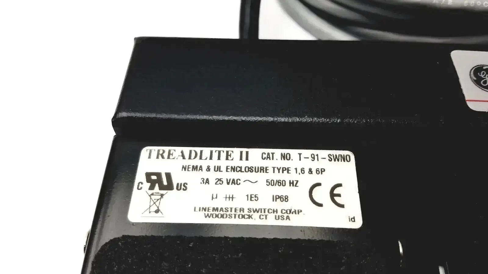 Black treadlite ii industrial electrical enclosure with white technical label on back of ge medical systems footswitch 3-padels ip68