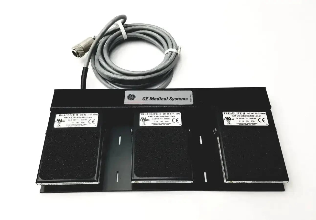 Black GE medical systems footswitch with three control pads and a coiled gray cable for medical systems use