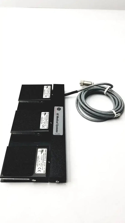 Black ge medical systems footswitch with three stacked modules and coiled gray cable for durable systems footswitch use