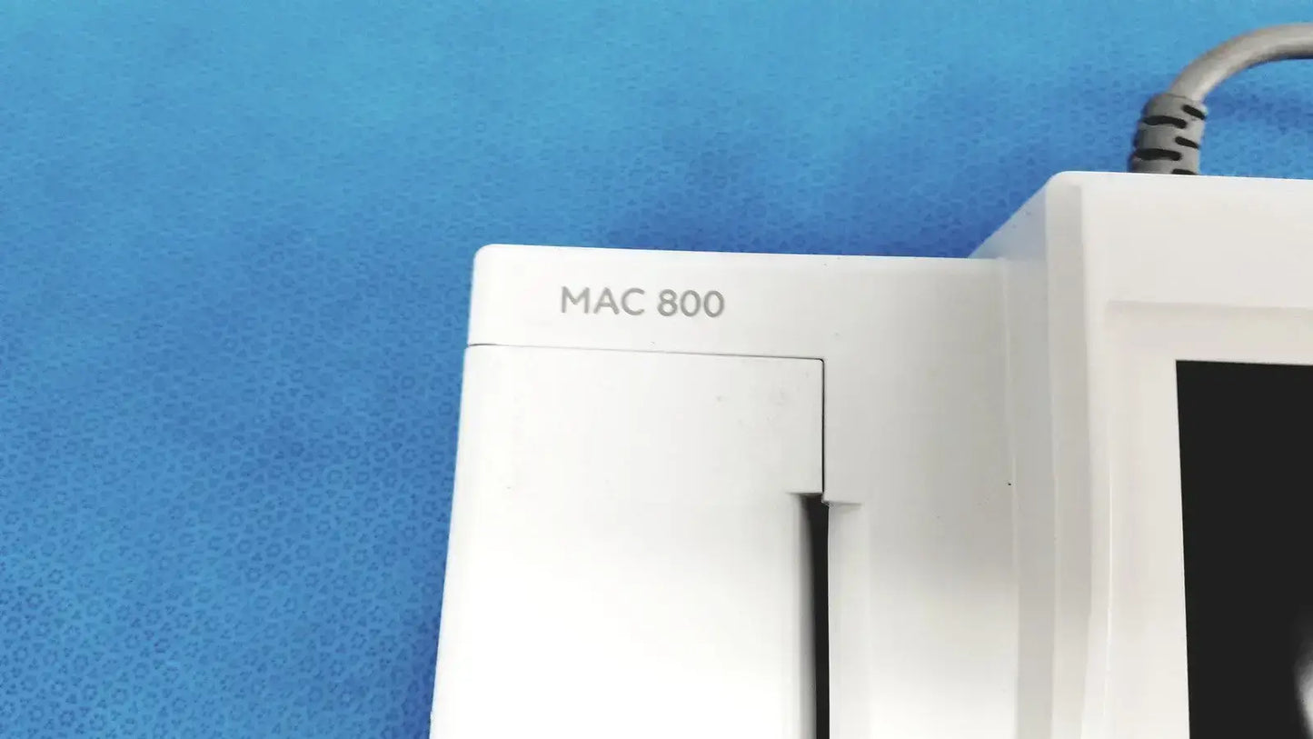White plastic ge medical systems mac 800 ecg machine monitor with matte finish and visible power cable