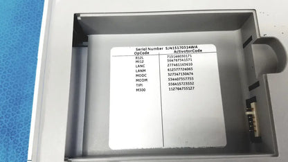 Gray plastic housing with white label showing serial number on the back of ge medical systems mac 800 ecg machine