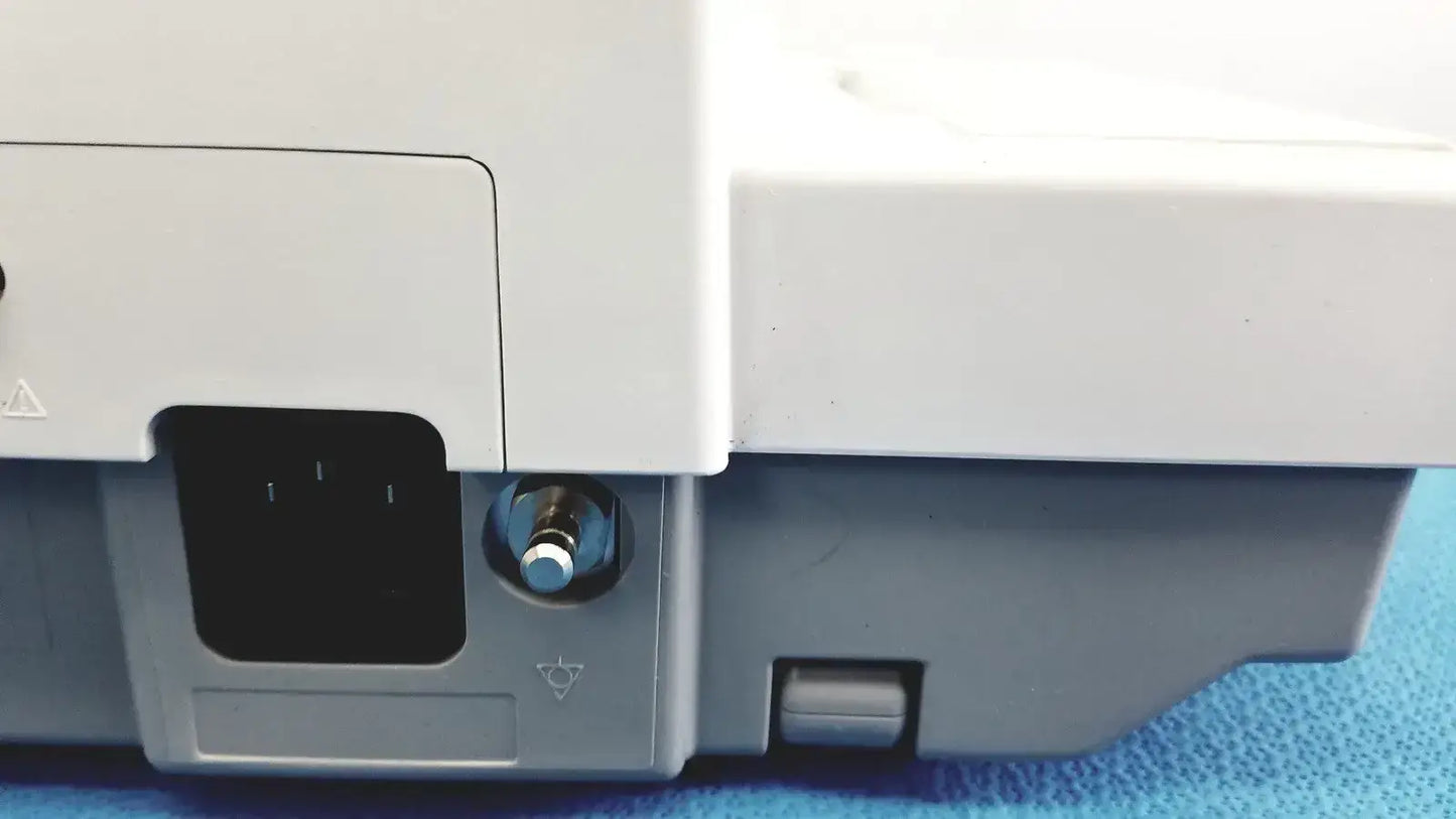 White and gray plastic base of ge medical systems mac 800 ecg machine with metallic power button on the front side