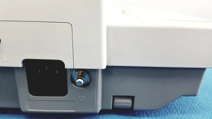 White and gray plastic base of ge medical systems mac 800 ecg machine with metallic power button on the front side