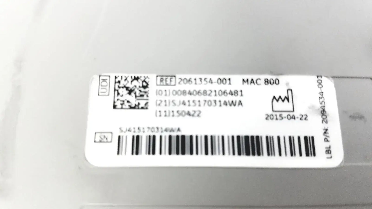 White rectangular label with black text barcode qr code and serial numbers on the back of ge medical systems mac 800 ecg machine