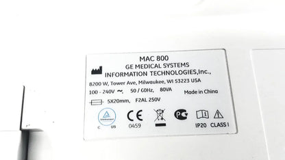 White rectangular label with black text showing specifications on the back of ge medical systems mac 800 ecg machine