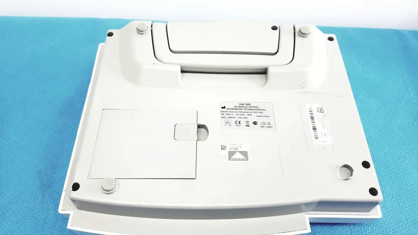 White plastic rectangular ecg machine with rounded edges and central lid by GE medical systems MAC 800 medical systems
