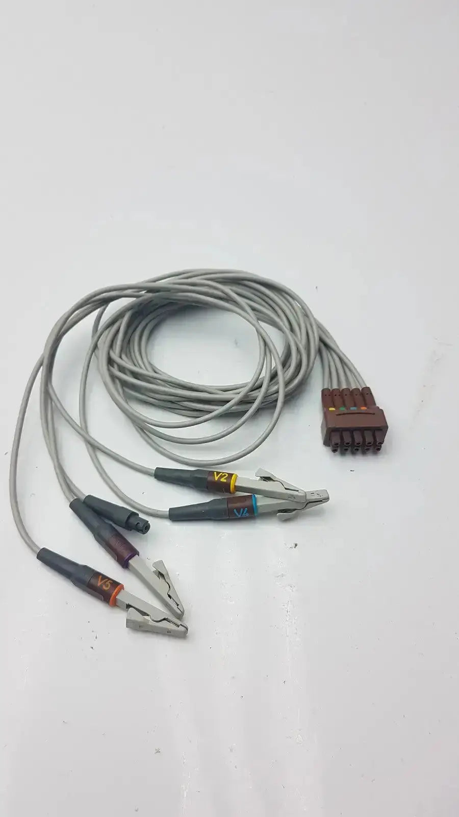 Gray coiled multi-link ecg leadwire with multiple alligator clips and brown multi-pin connector for leadwire 5-lead v2-6 use