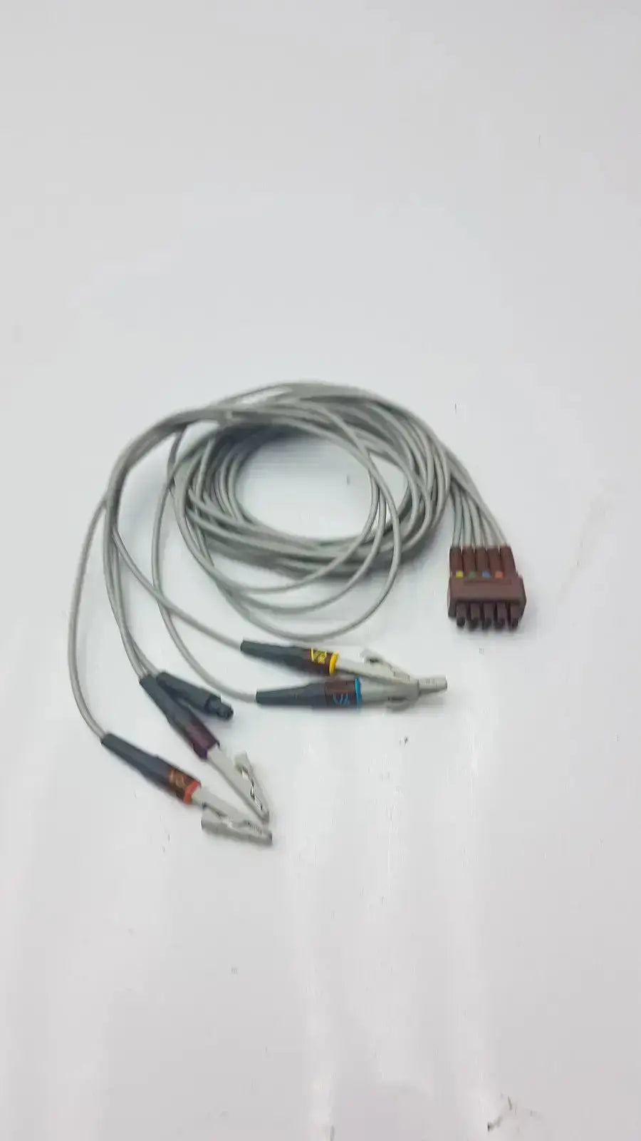 Gray coiled multi-link ecg leadwire 5-lead v2-6 with multiple alligator clips and brown multi-pin connector for medical use