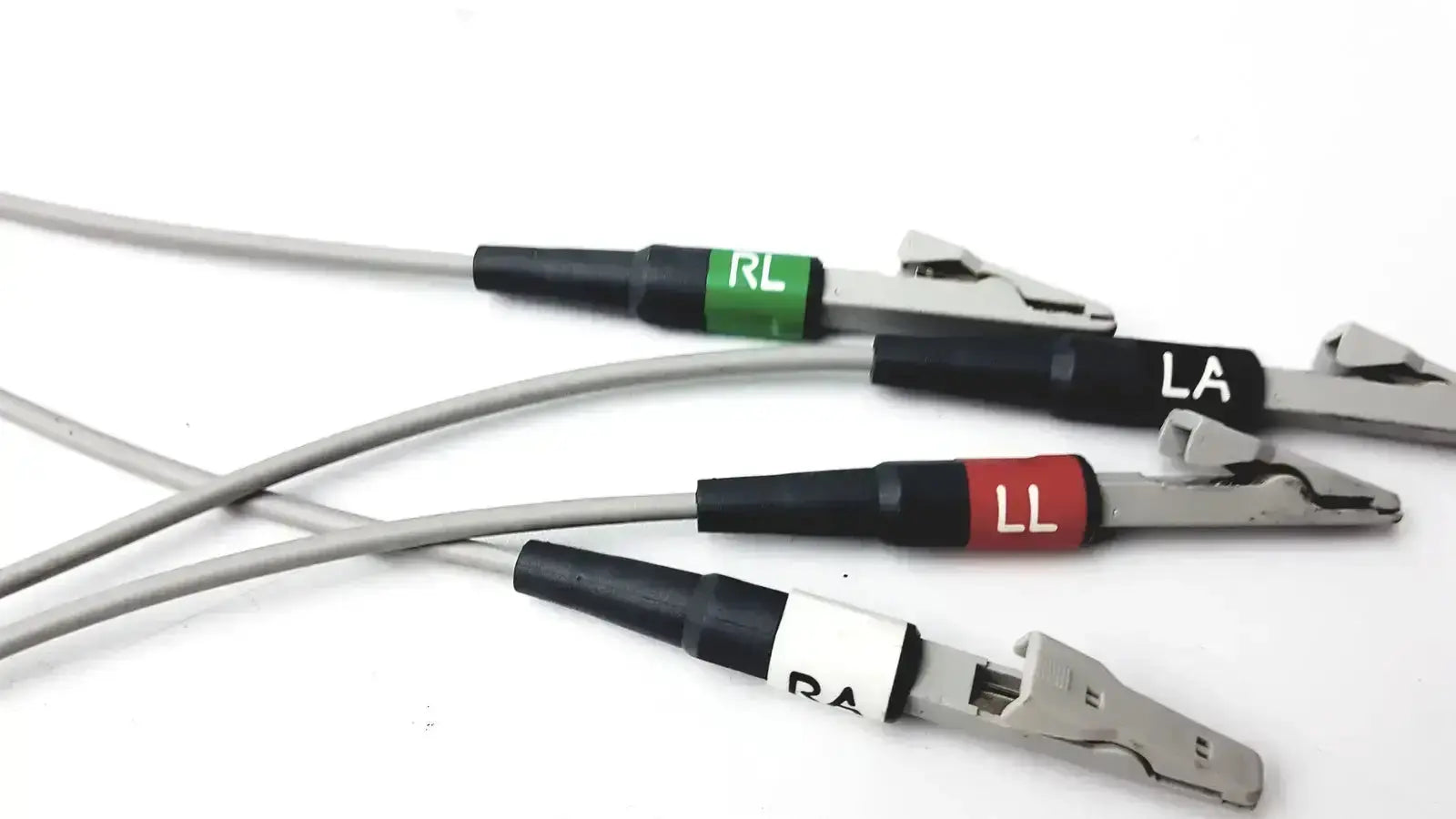Set of four medical-grade silver test clips with black handles and color-coded labels for GE multi-link lead trunk cable