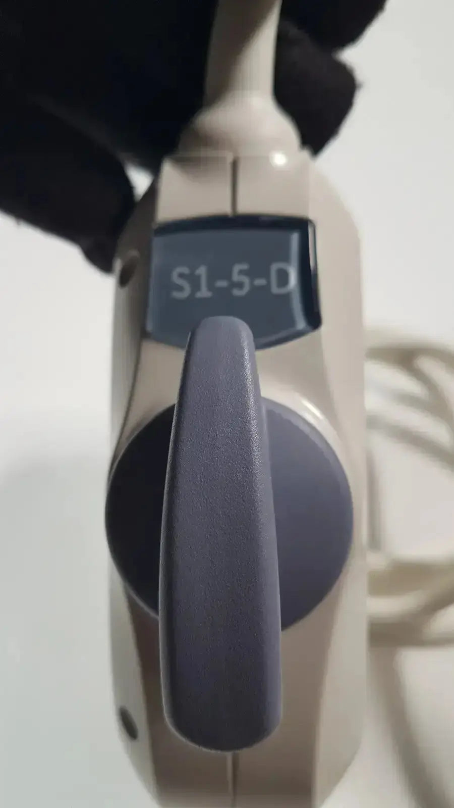 Beige GE s1-5-d phased array ultrasound probe with dark gray textured grip and digital display for medical imaging