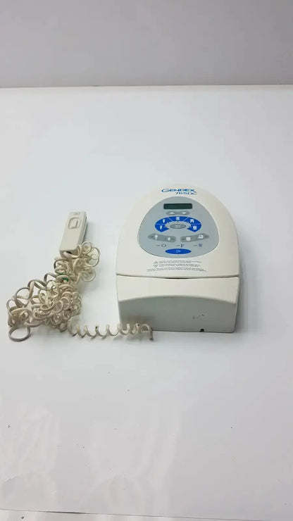 Cream-colored Gendex 765DC Xray remote control panel with blue-lit control panel and coiled cord for precise remote control