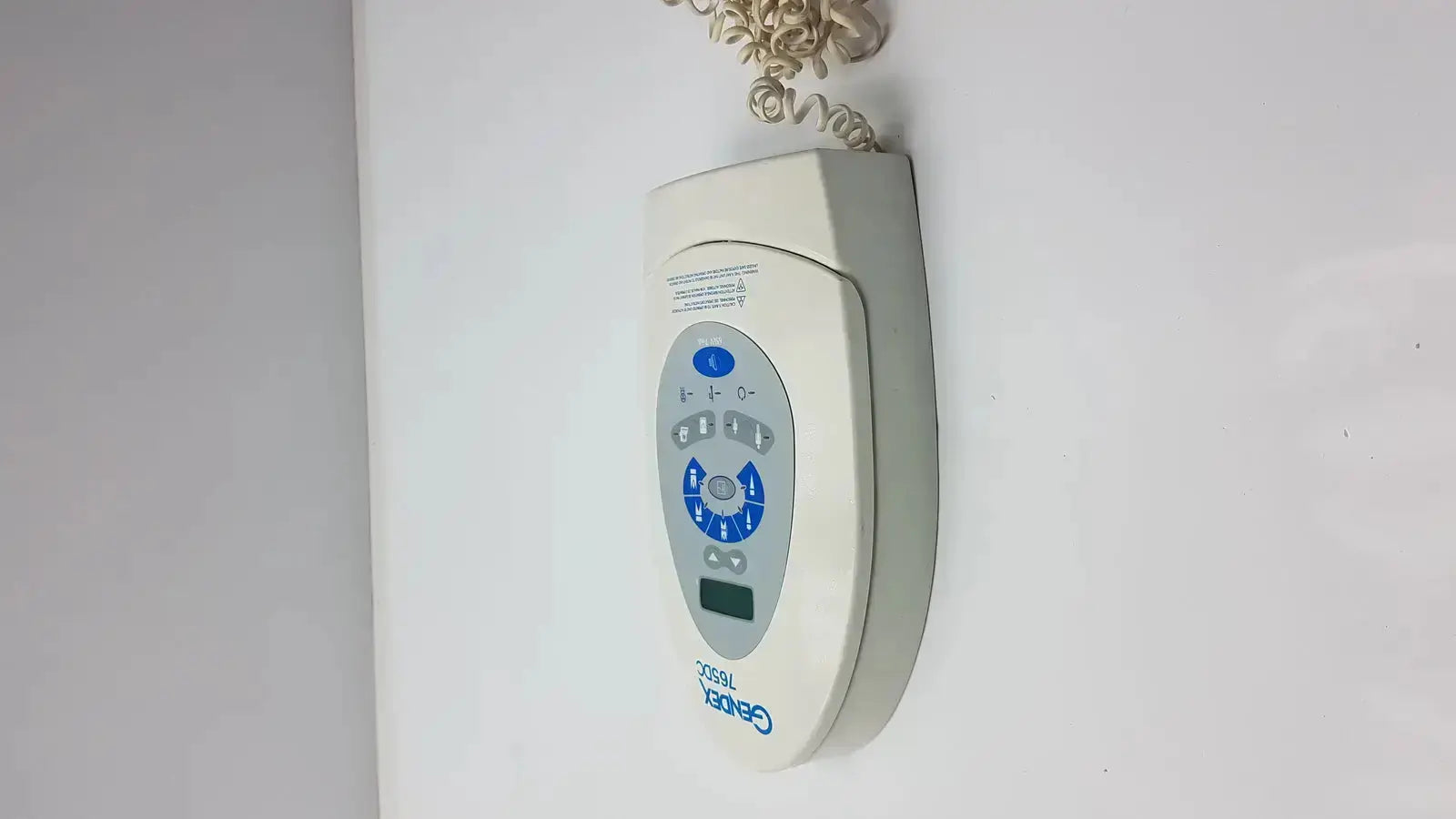 Beige Gendex 765DC Xray remote control panel with blue buttons and small digital display for precise remote control use