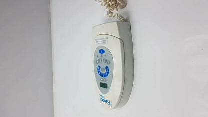 Beige Gendex 765DC Xray remote control panel with blue buttons and small digital display for precise remote control use