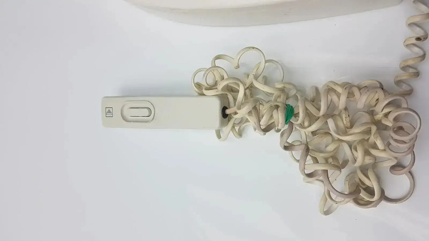 Beige plastic gendex 765dc xray remote control panel with coiled beige cord for precise remote control use