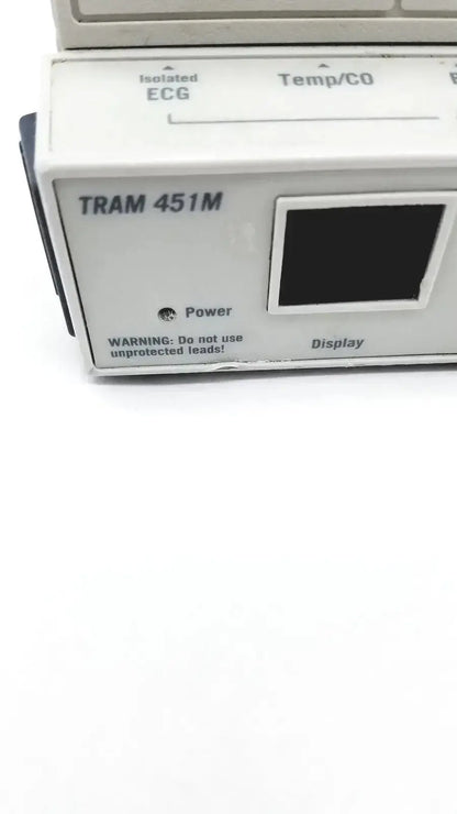 White plastic medical tram 451m module with black display and labeled functions for patient monitoring by general electric