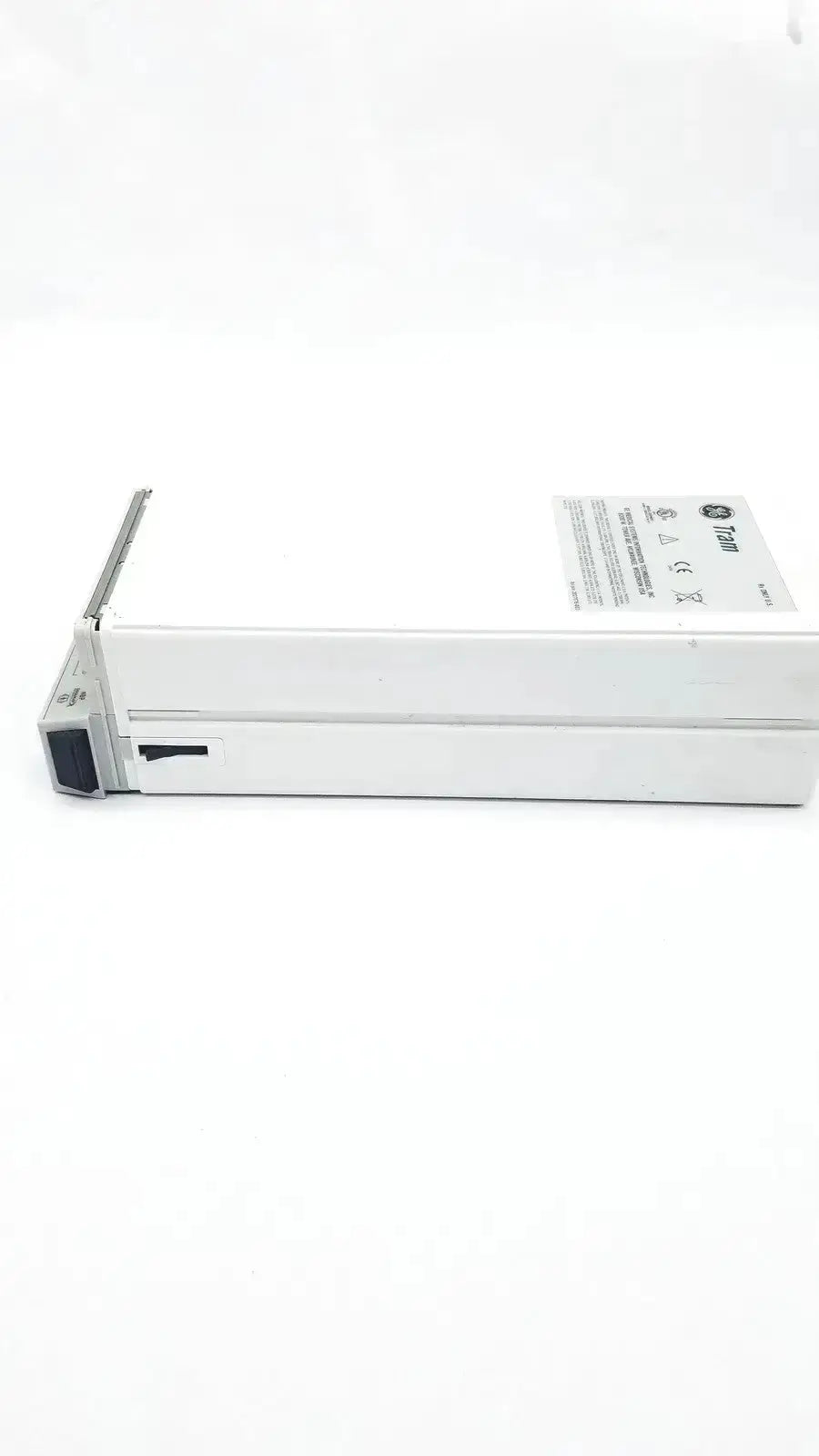 White metal server drive bay with label and black latch for the medical tram 451m patient monitor module