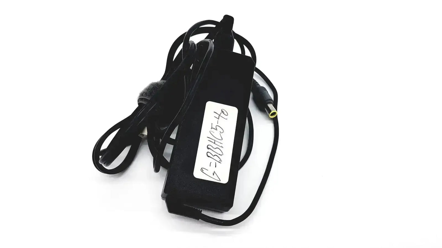 Black plastic lenovo 90w power supply with coiled cord and white label featuring round tip 42t5000 connection