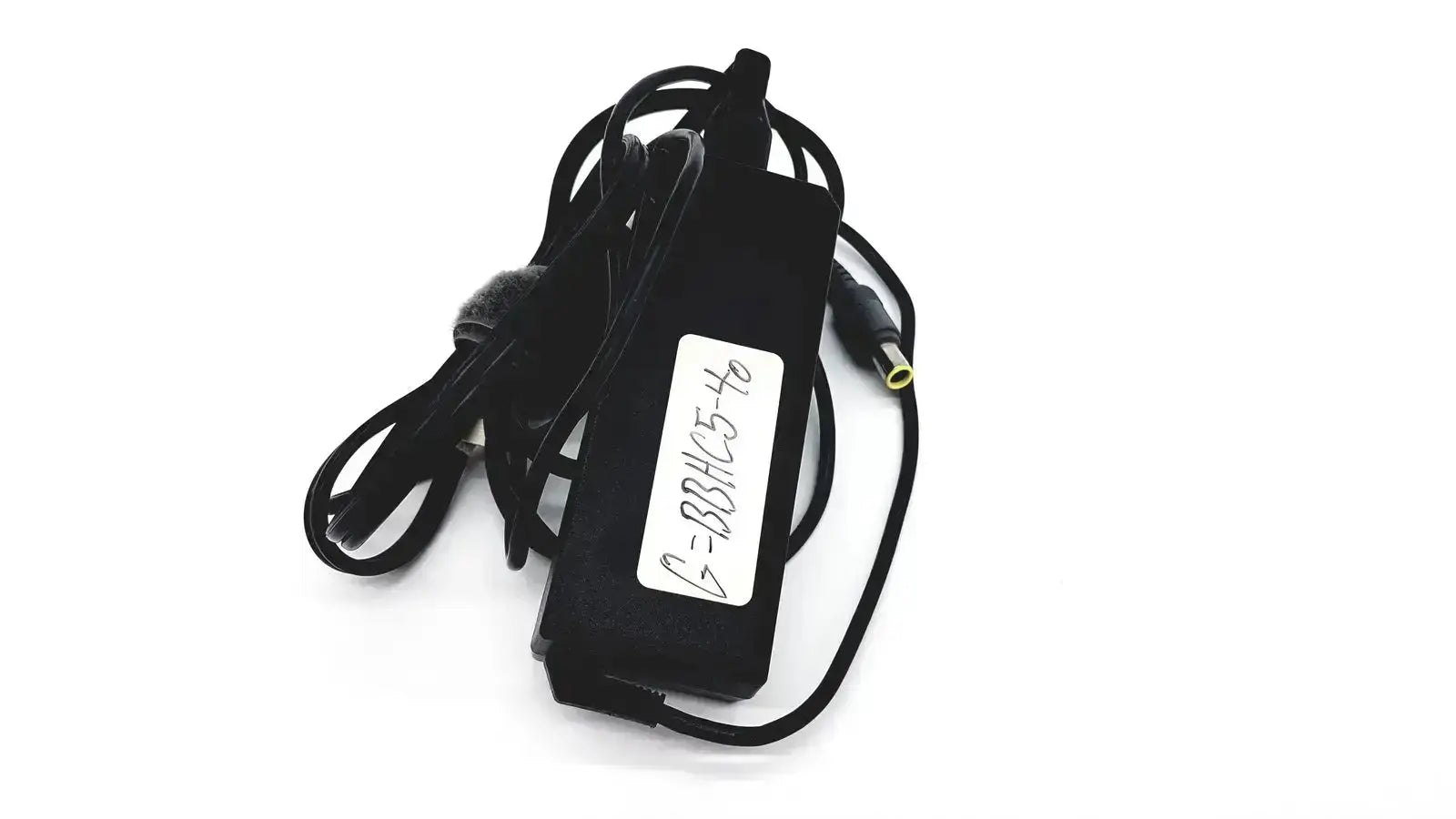 Black plastic lenovo 90w power supply with coiled cord and white label featuring round tip 42t5000 connection