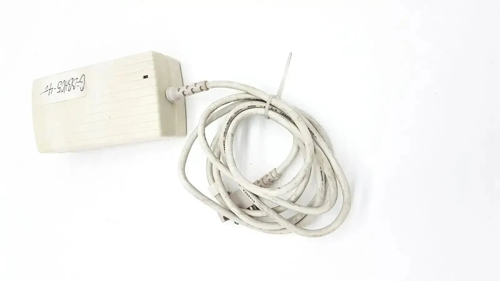Off-white rectangular spacelabs snp-a085-3y power adapter with coiled gray cable used medical equipment for sale